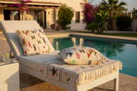 Handwoven Moroccan Berber cushion set beside a swimming pool